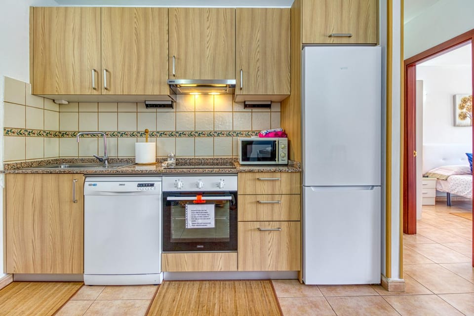 Kitchen or kitchenette, dishwasher, oven, stove, toaster