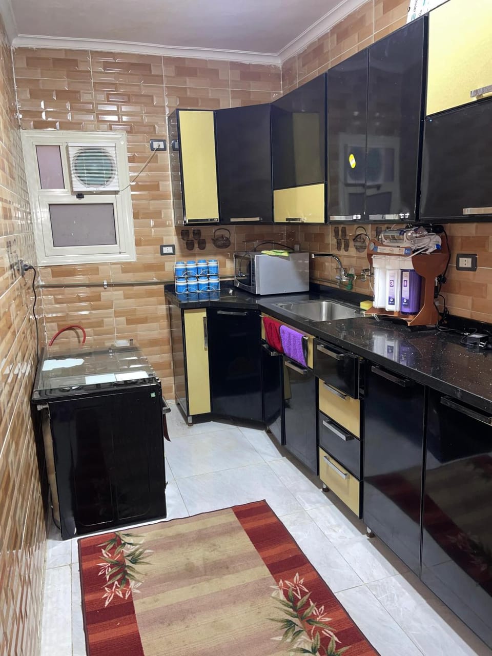Kitchen or kitchenette, dishwasher, oven, stove