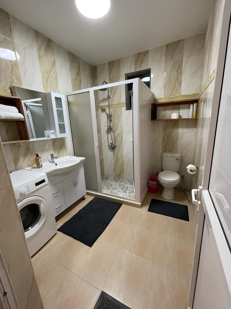 Shower, Toilet, Bathroom, hair dryier, towels, washing machine