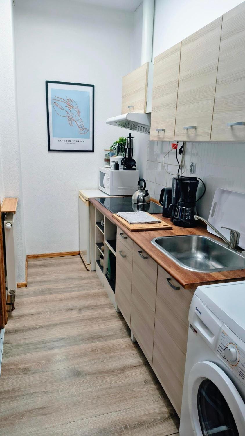 Kitchen or kitchenette, microwave, stove, washing machine