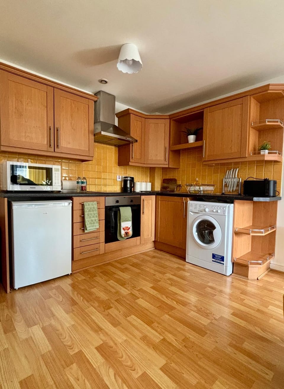 Kitchen or kitchenette, oven, stove, toaster, washing machine