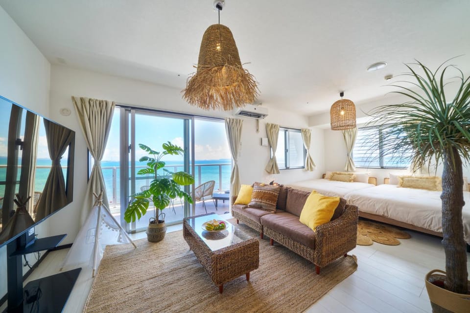 Bed, Natural landscape, TV and multimedia, Living room, Seating area, Bedroom, Sea view