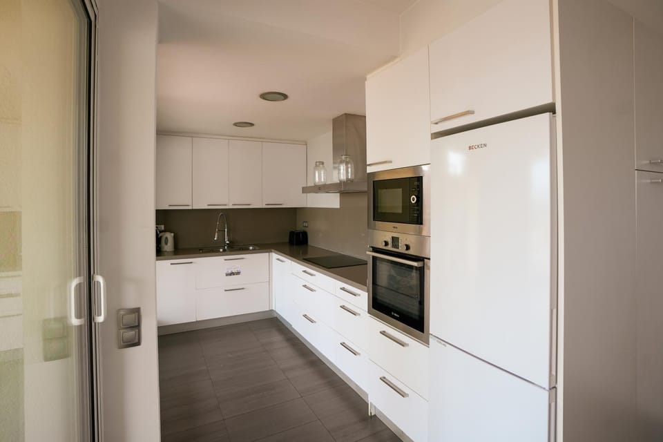 Kitchen or kitchenette, dishwasher, oven, stove