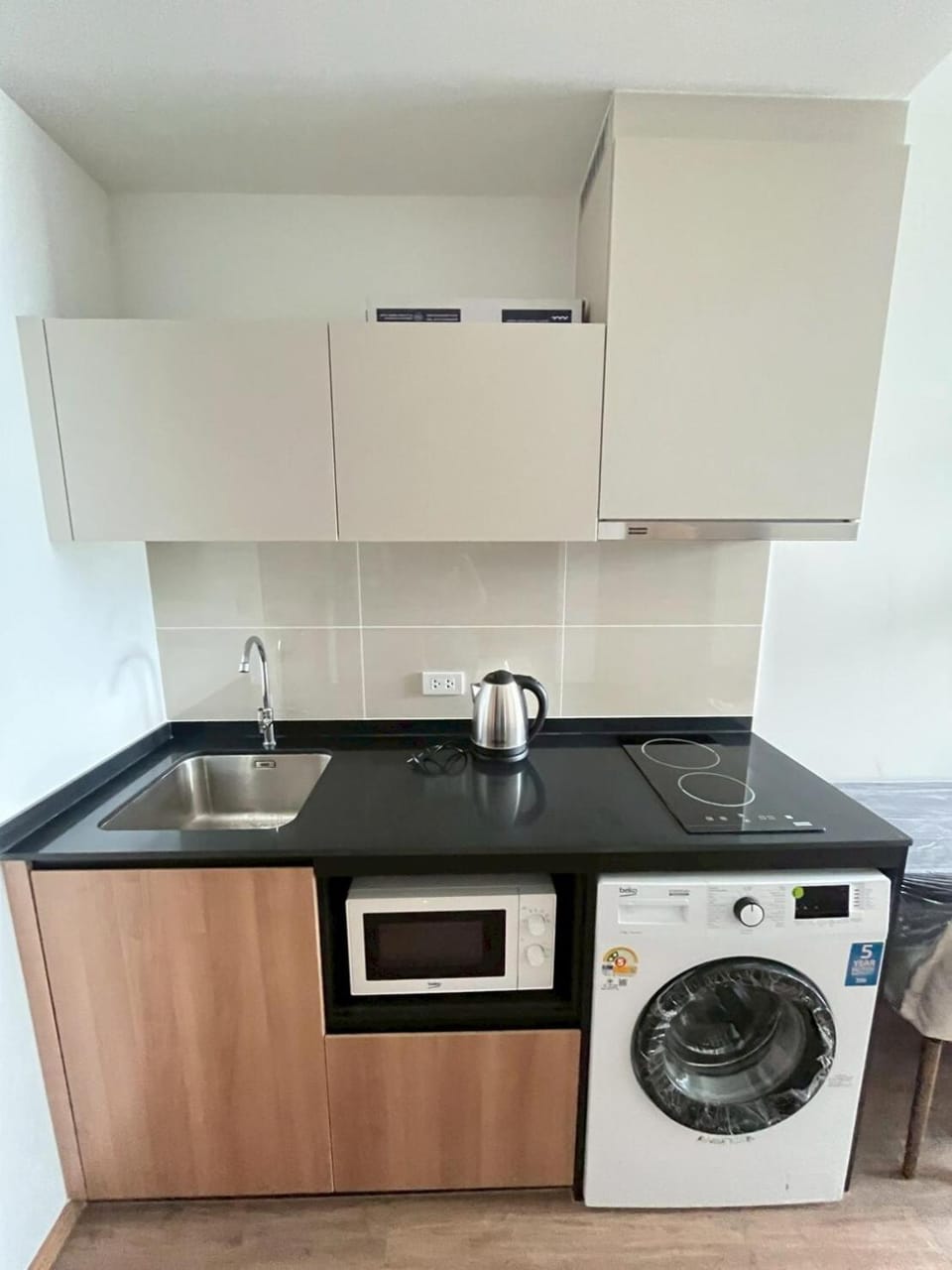 Kitchen or kitchenette, microwave, stove, washing machine