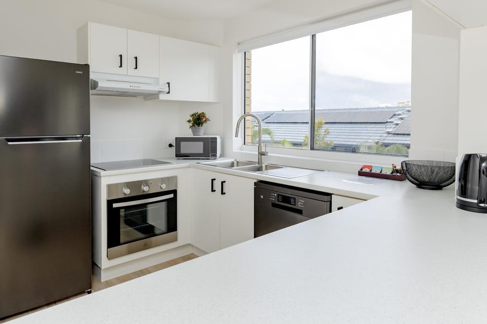 Kitchen or kitchenette, dishwasher, oven, stove, toaster