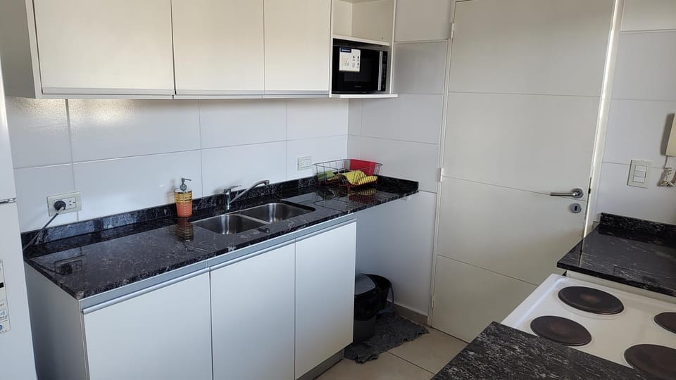 Photo of the whole room, microwave, oven, stove, kitchen