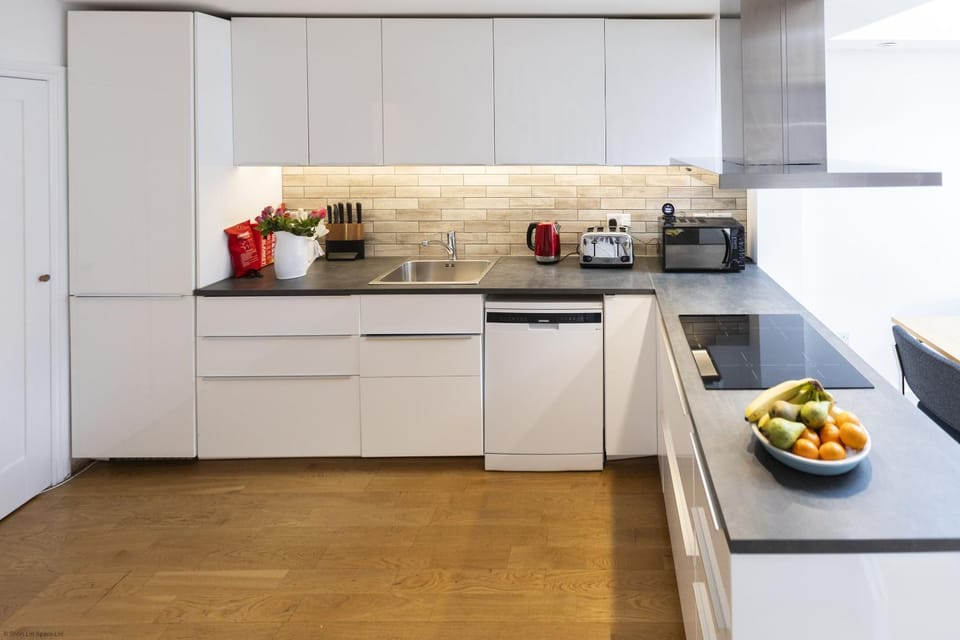 Kitchen or kitchenette, dishwasher, microwave, stove, toaster