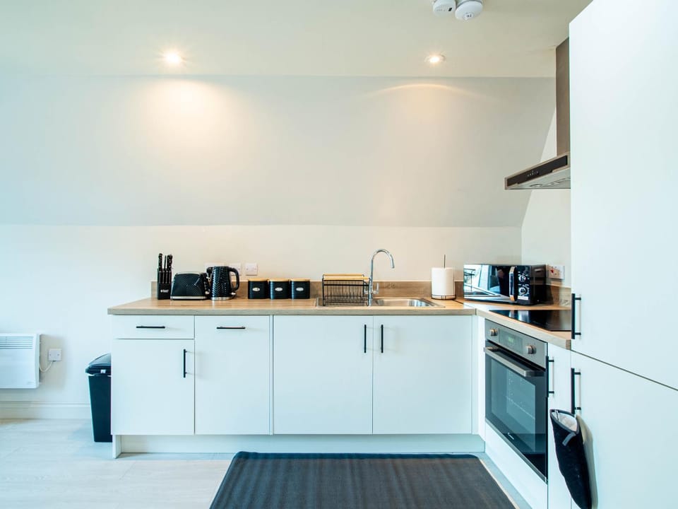 Kitchen or kitchenette, dishwasher, oven, stove, toaster