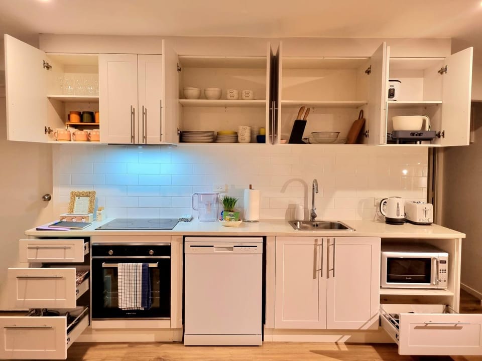 Kitchen or kitchenette, dishwasher, microwave, oven, stove, toaster