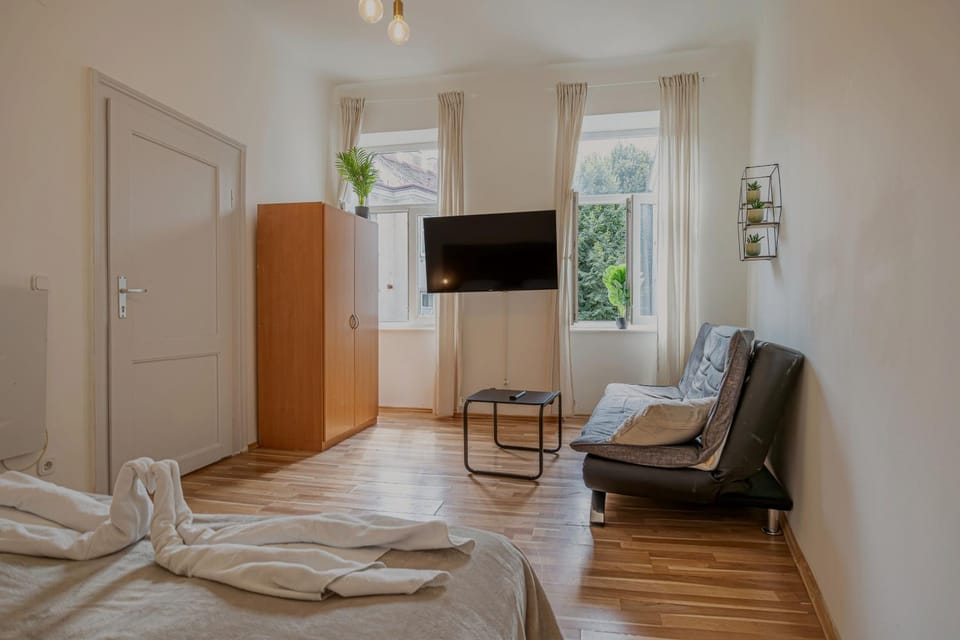 Bed, TV and multimedia, Seating area, Bedroom, towels, wardrobe