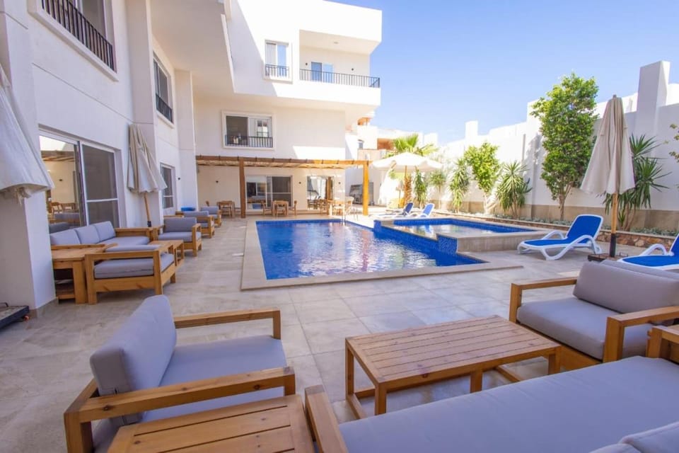 Property building, Patio, Day, Seating area, Pool view, Swimming pool, sunbed