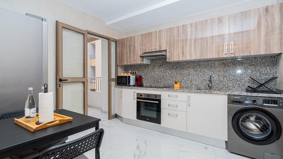 Kitchen or kitchenette, dishwasher, oven, stove, toaster, washing machine