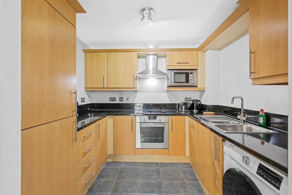 Kitchen or kitchenette, dishwasher, oven, toaster, washing machine, dryer