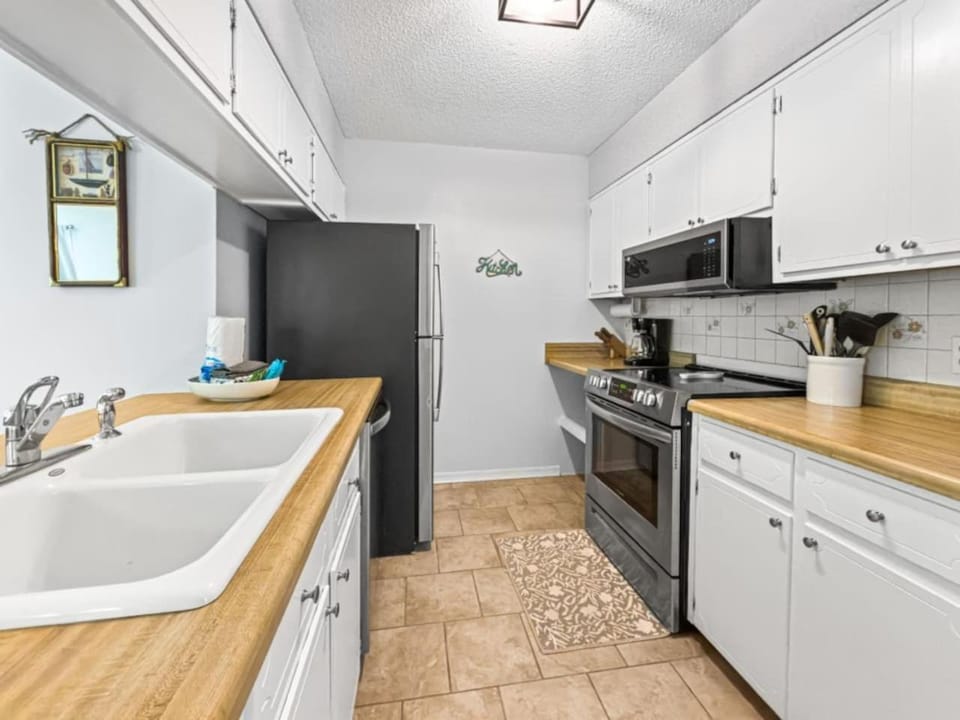 Kitchen or kitchenette, dishwasher, oven, stove