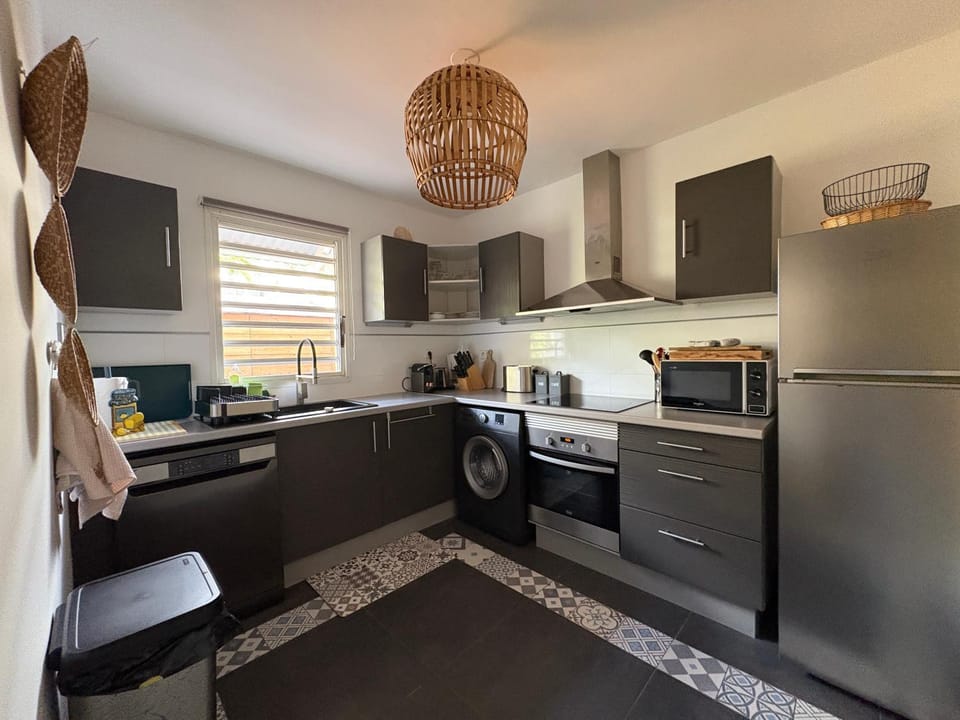Kitchen or kitchenette, dishwasher, oven, stove, toaster, washing machine