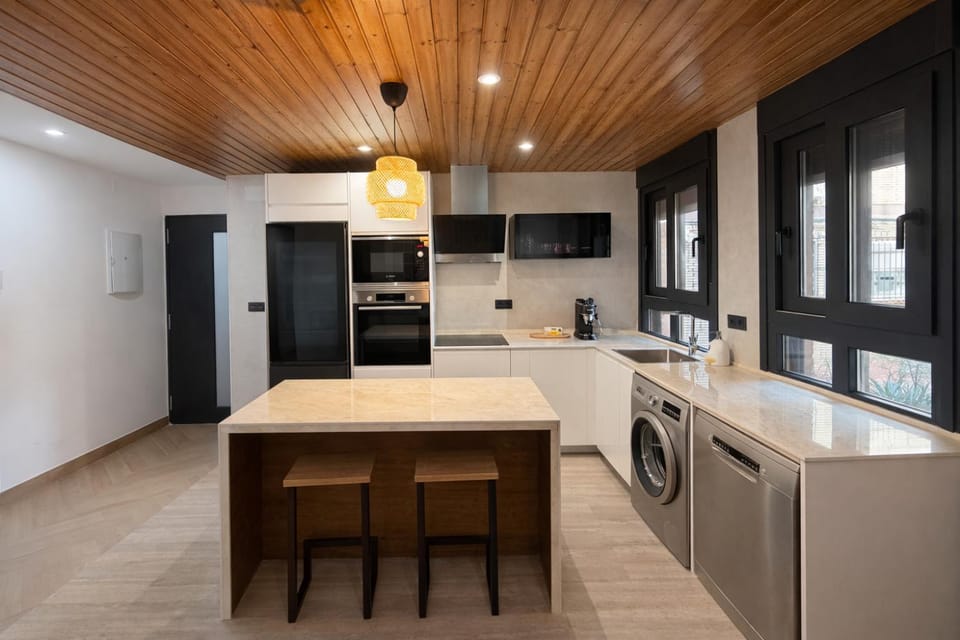 Kitchen or kitchenette, dishwasher, oven, stove, toaster, washing machine
