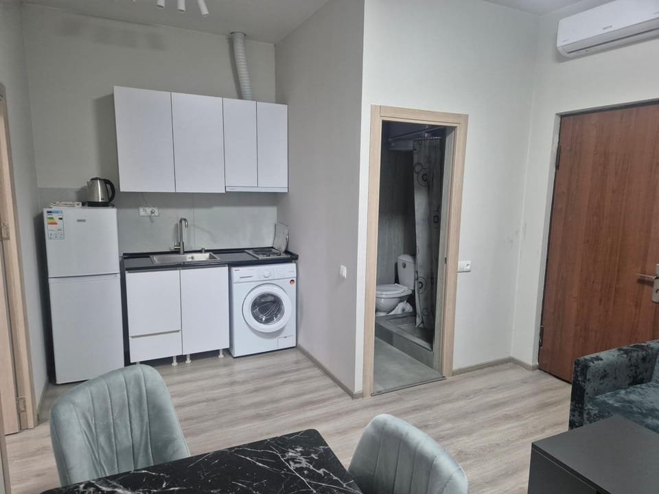 Kitchen or kitchenette, Living room, Seating area, stove, washing machine, dryer, air conditioner