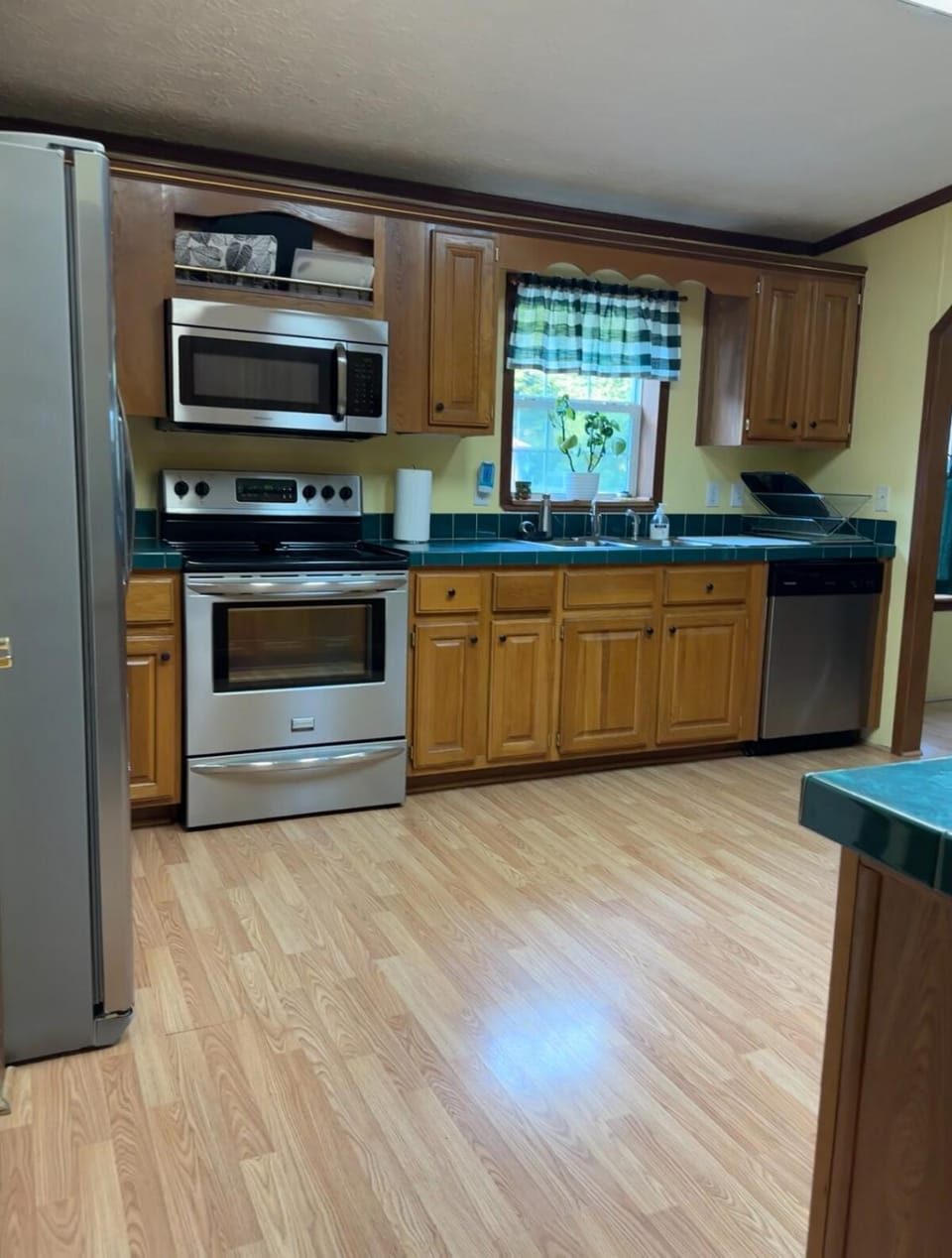 Kitchen or kitchenette, dishwasher, microwave, oven, stove, toaster