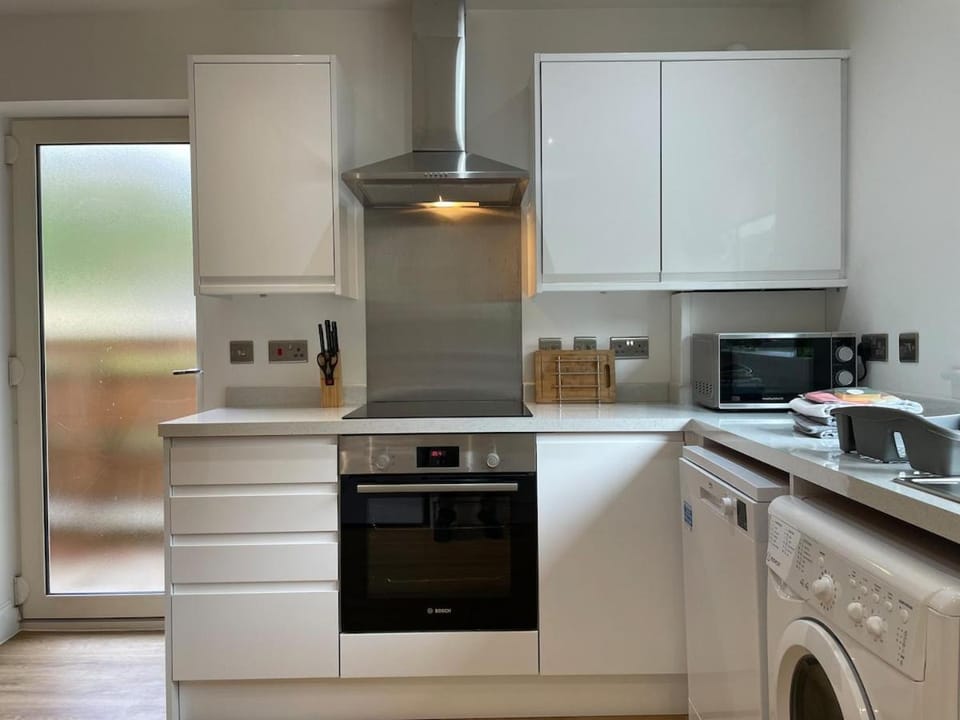 Kitchen or kitchenette, microwave, oven, stove, toaster, washing machine