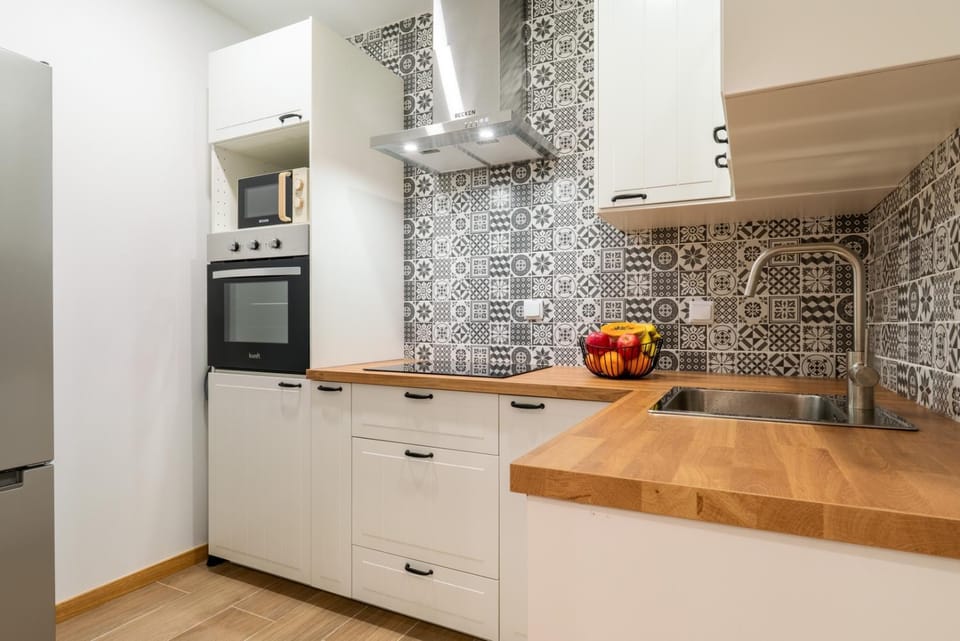 Kitchen or kitchenette, dishwasher, oven, stove