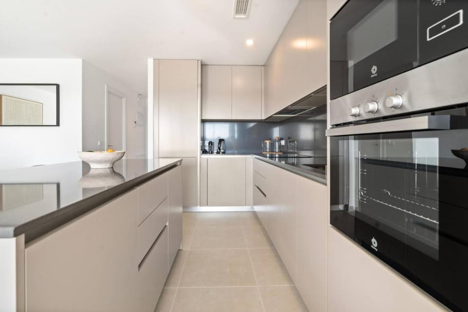 Kitchen or kitchenette, dishwasher, oven, stove