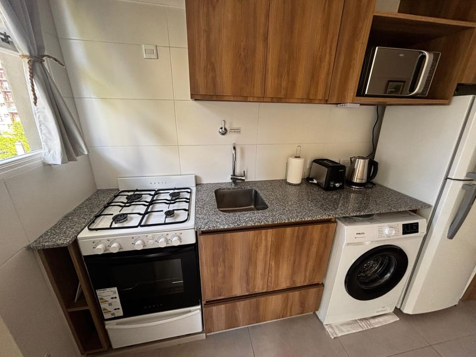 Kitchen or kitchenette, oven, stove, toaster, washing machine