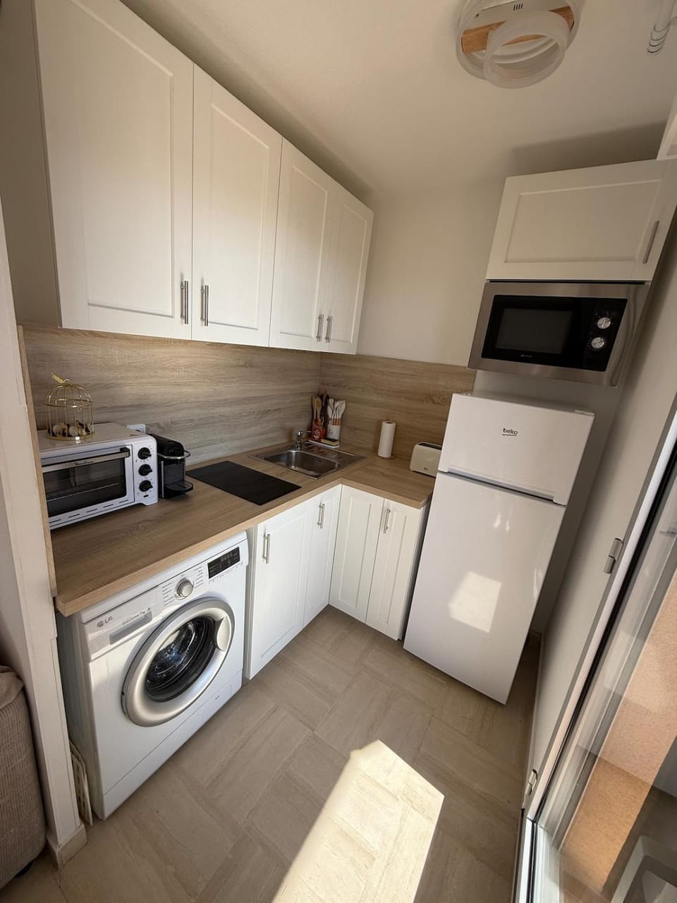 Kitchen or kitchenette, oven, stove, toaster, washing machine