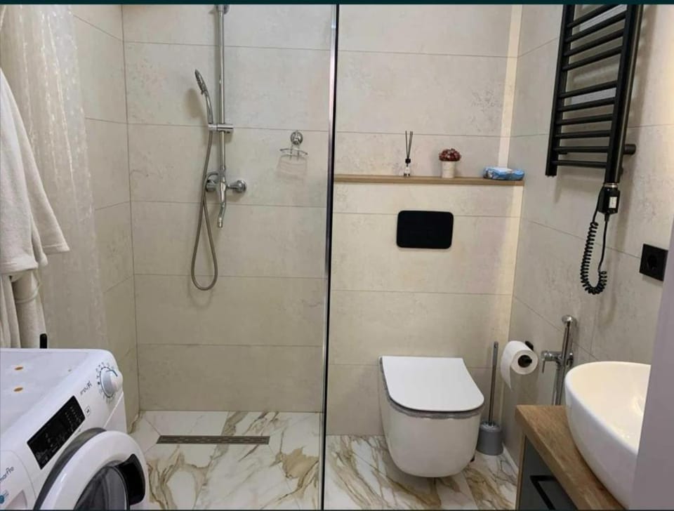 Shower, Toilet, towels, washing machine, dryer