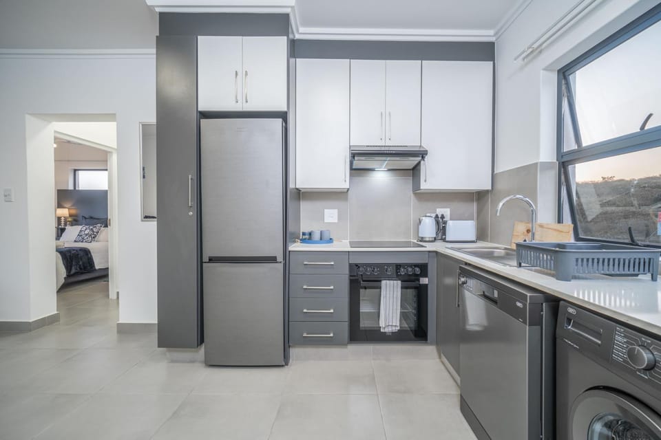 Kitchen or kitchenette, dishwasher, oven, stove, toaster, washing machine, dryer