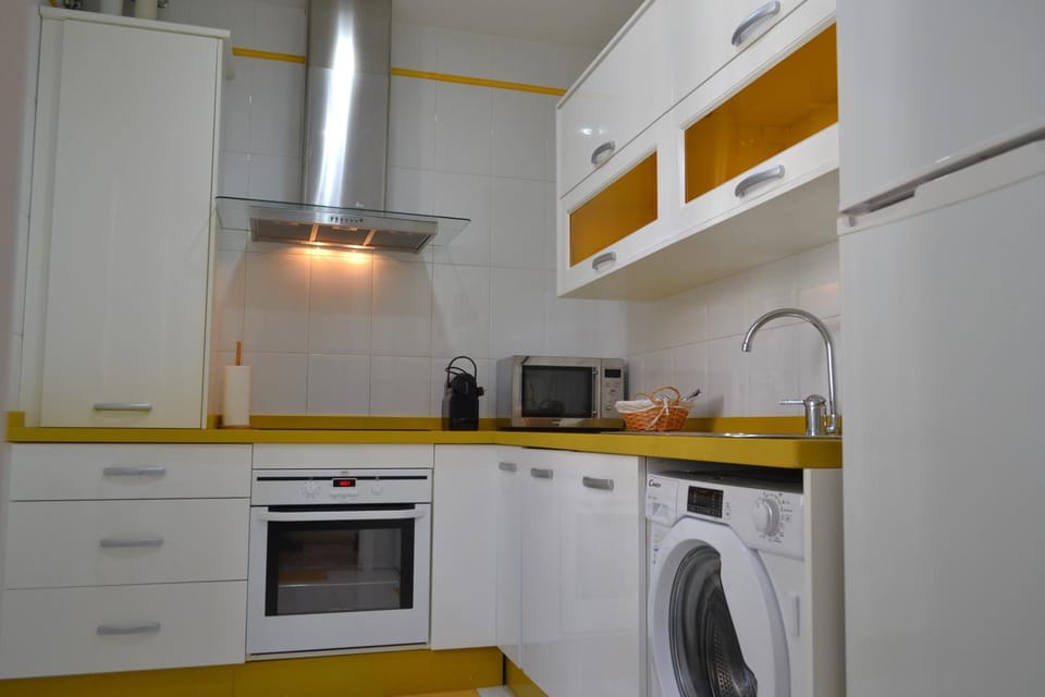 Kitchen or kitchenette, dishwasher, oven, stove, toaster, washing machine