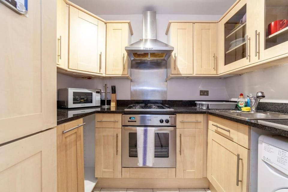 Kitchen or kitchenette, dishwasher, microwave, oven, stove