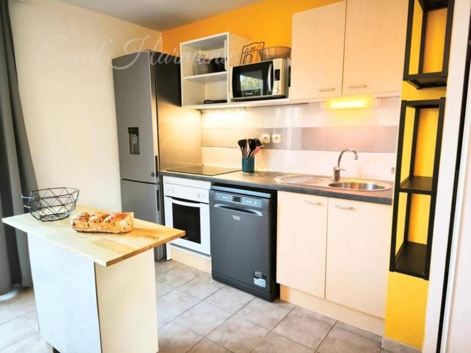 Kitchen or kitchenette, dishwasher, oven, stove