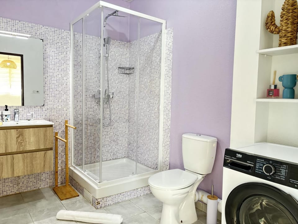 Shower, Toilet, Bathroom, hair dryier, towels, washing machine