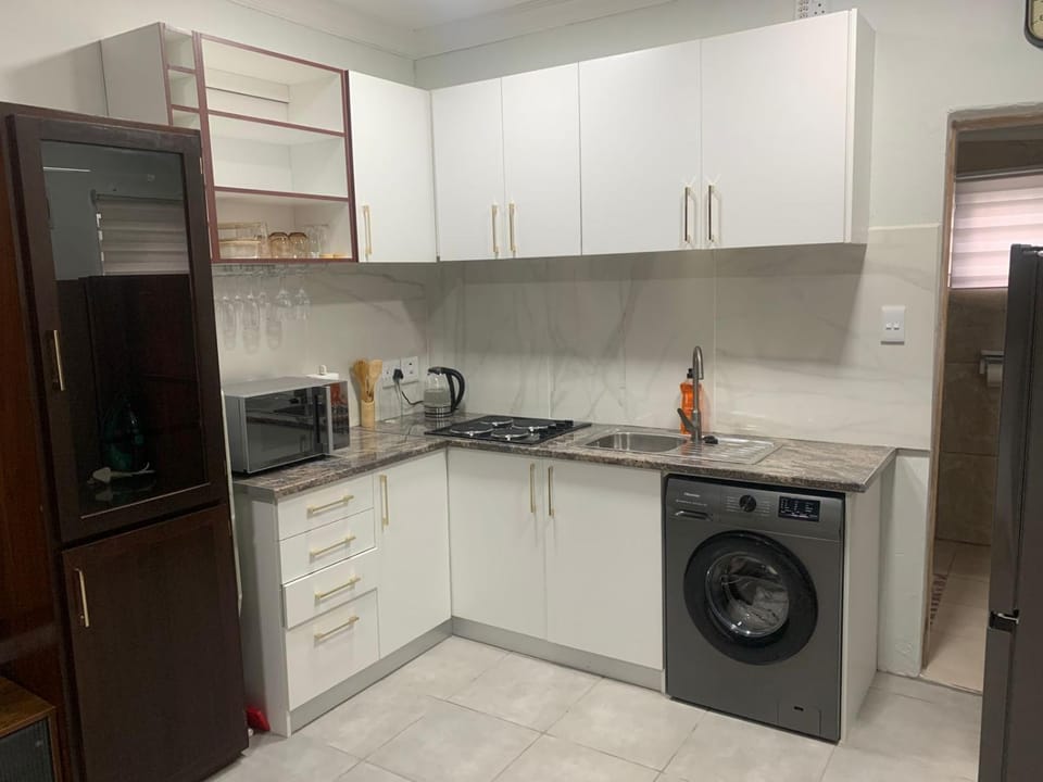 Kitchen or kitchenette, microwave, stove, washing machine