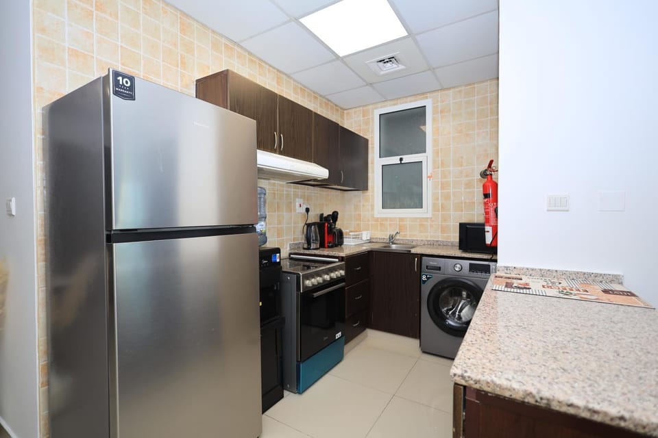 Kitchen or kitchenette, oven, stove, toaster, washing machine