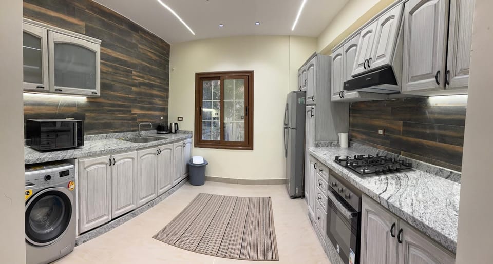Kitchen or kitchenette, microwave, oven, washing machine