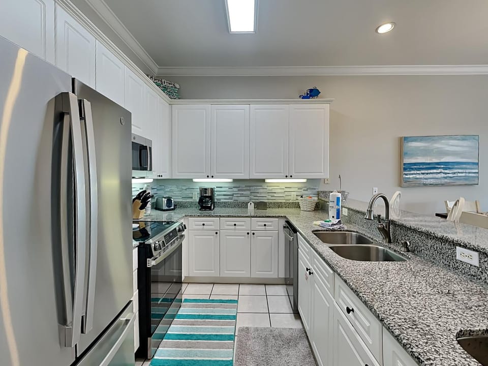 Kitchen or kitchenette, dishwasher, furniture, microwave, oven, stove, toaster, kitchen