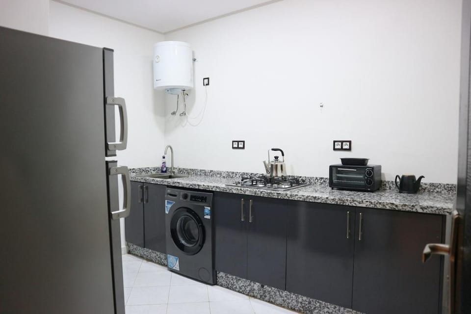 Kitchen or kitchenette, stove, washing machine