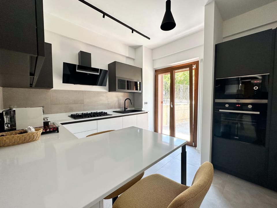 Kitchen or kitchenette, dishwasher, oven, stove