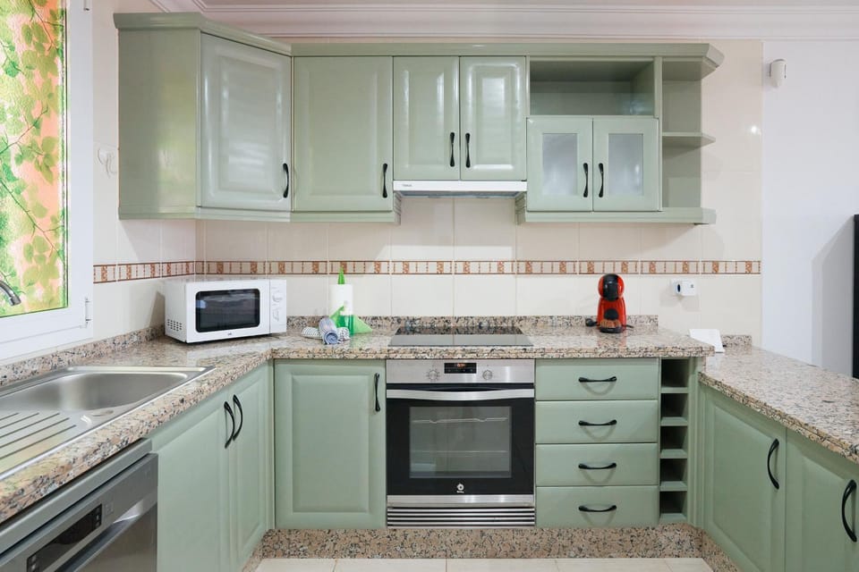Kitchen or kitchenette, dishwasher, oven, stove