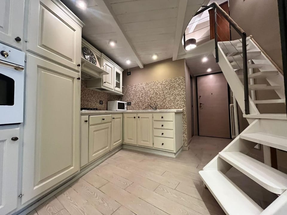 Kitchen or kitchenette, dishwasher, oven, stove