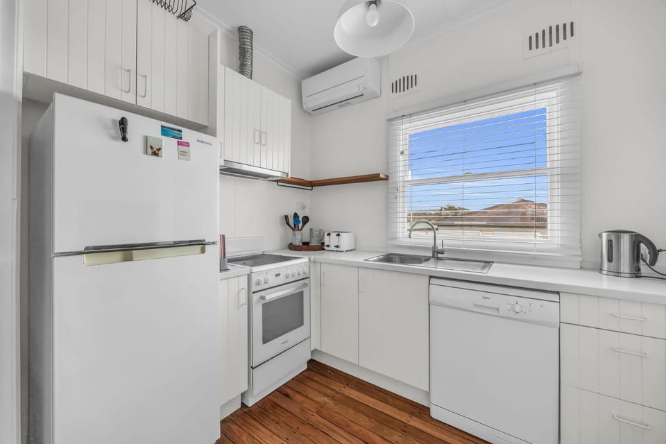 Kitchen or kitchenette, dishwasher, oven, stove, toaster, air conditioner