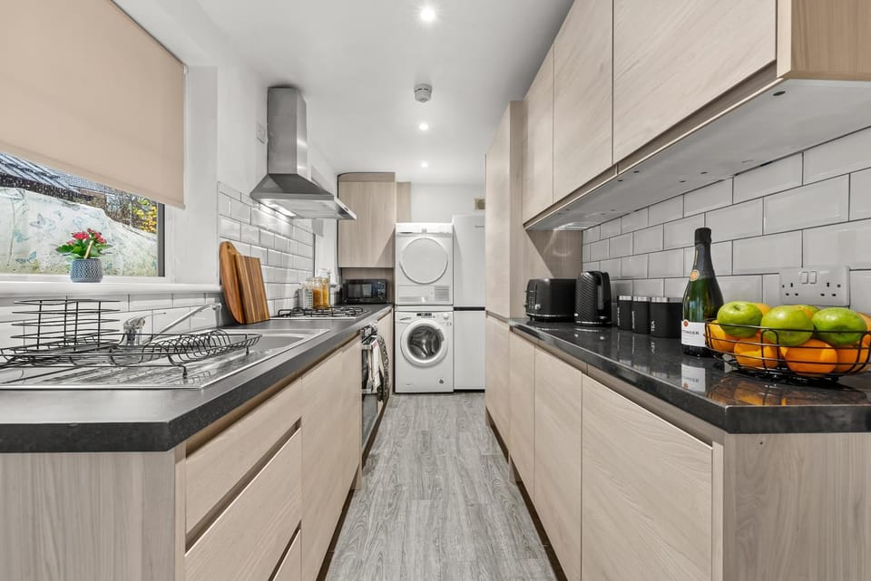 Kitchen or kitchenette, dishwasher, oven, stove, toaster, washing machine, dryer