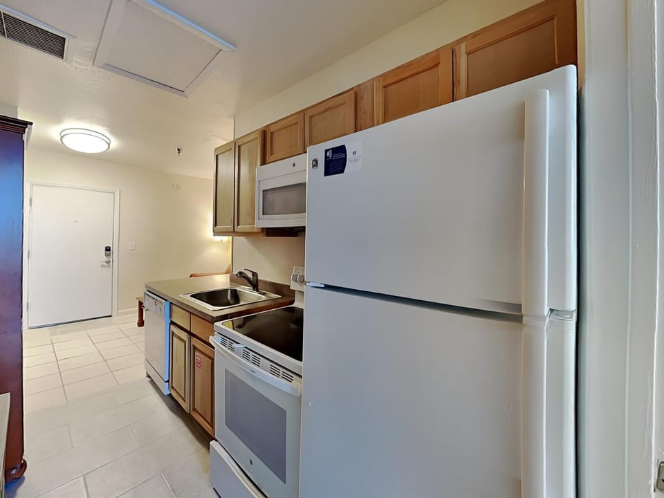 Kitchen or kitchenette, furniture, microwave, oven, stove, air conditioner