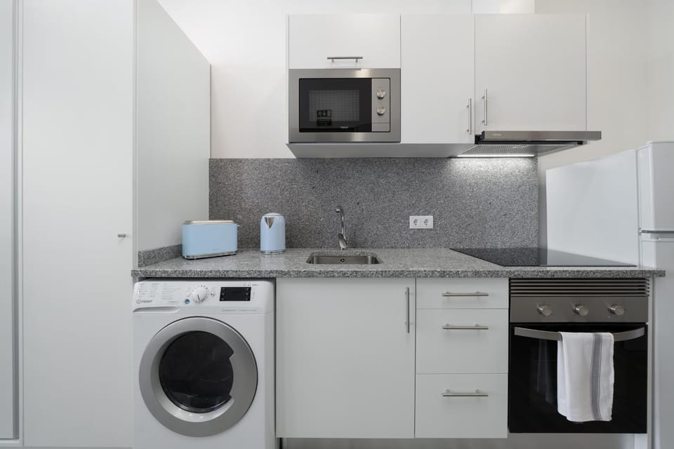 Kitchen or kitchenette, stove, washing machine