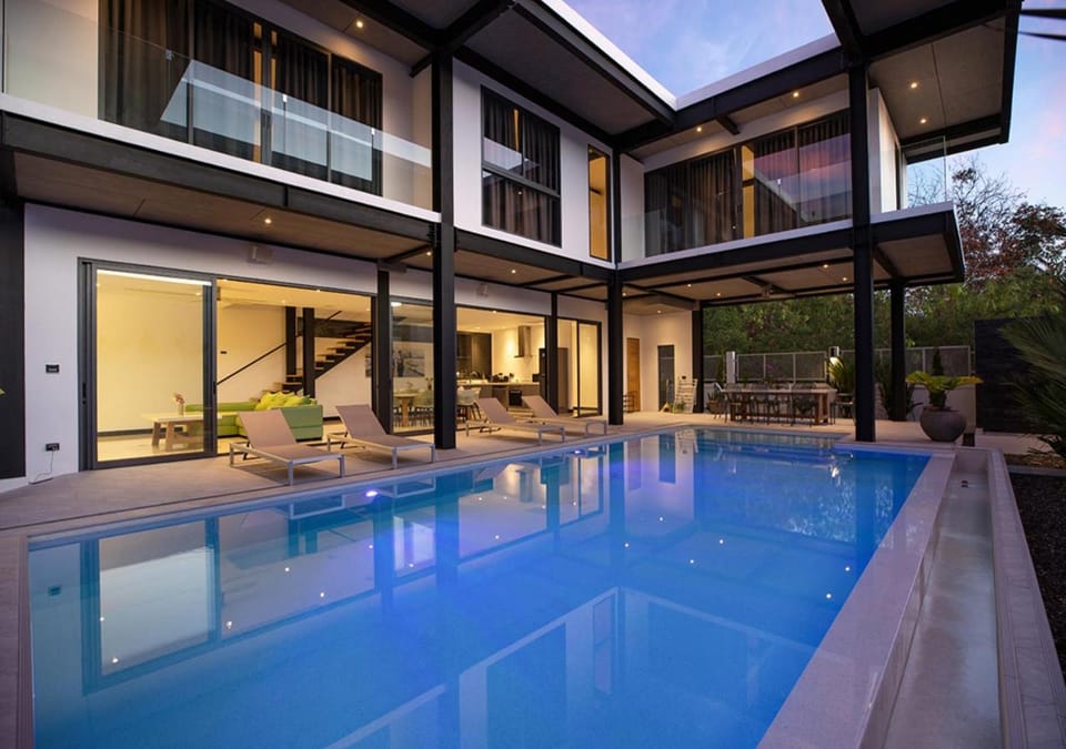 Property building, Patio, Night, Pool view, Swimming pool, sunbed
