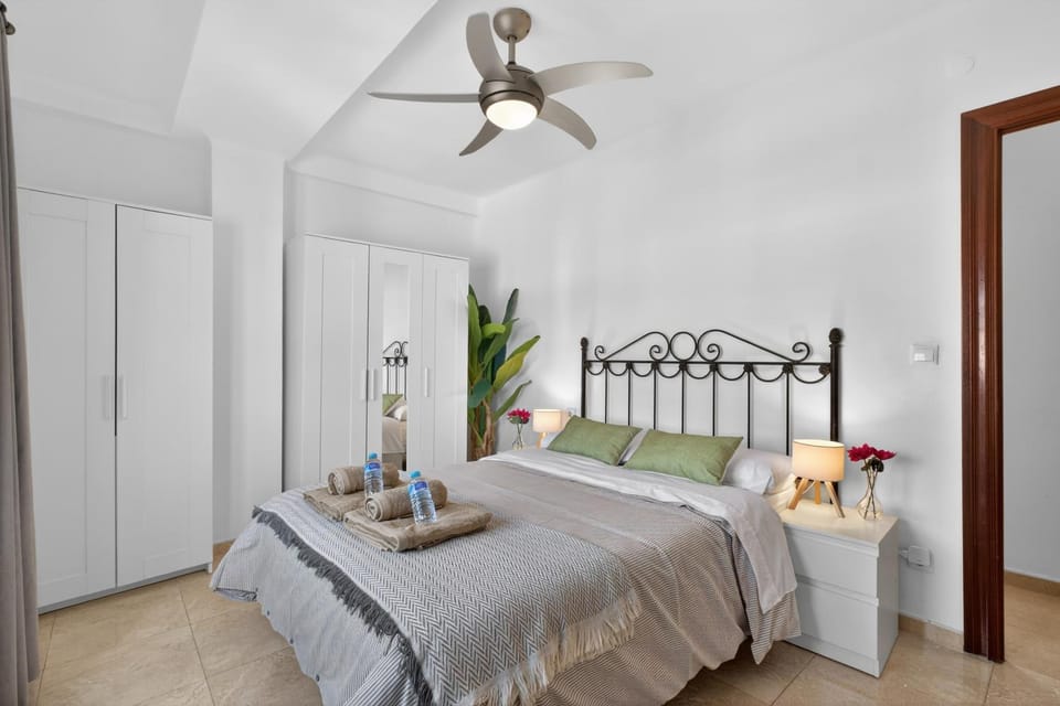 Bed, Decorative detail, towels, wardrobe, air conditioner