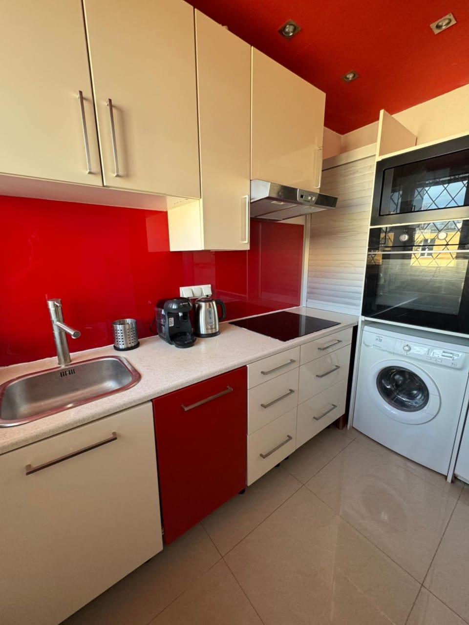 Kitchen or kitchenette, microwave, oven, stove, washing machine