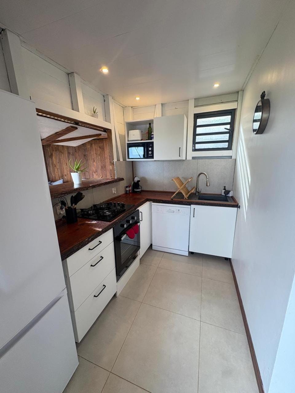 Kitchen or kitchenette, dishwasher, microwave, oven, stove