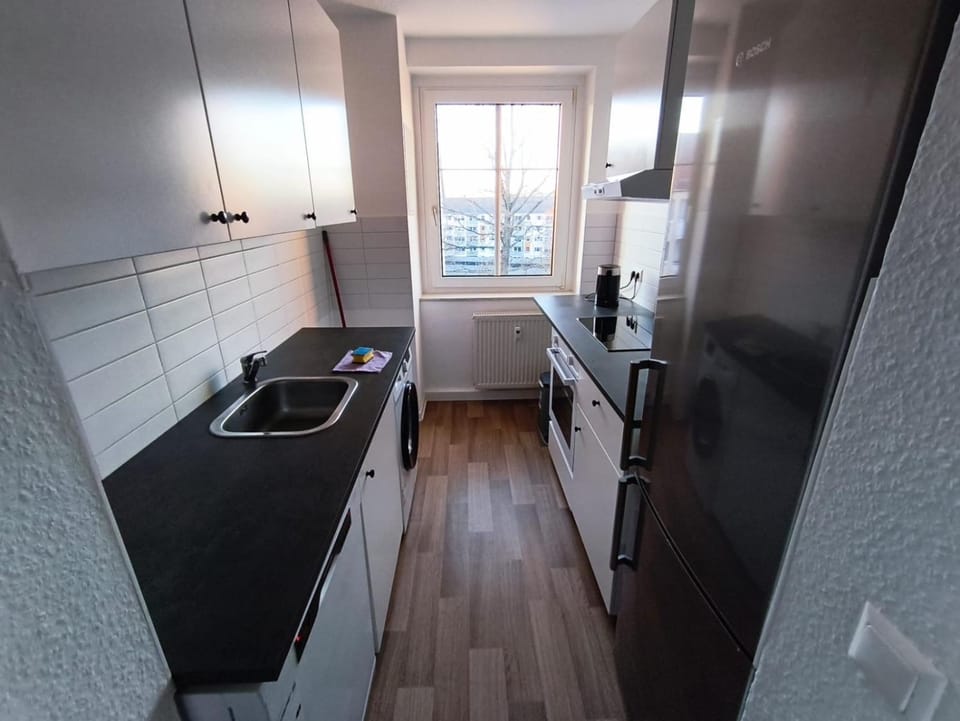 Kitchen or kitchenette, dishwasher, oven, stove